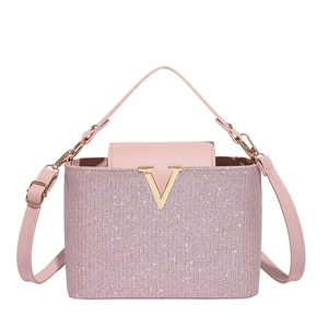 Pink glitter handbag with gold V-shaped buckle and matching leather shoulder strap