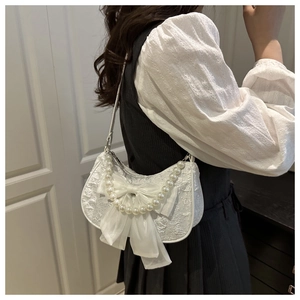 Lace shoulder bag with large white silk bow and elegant pearl strap detail