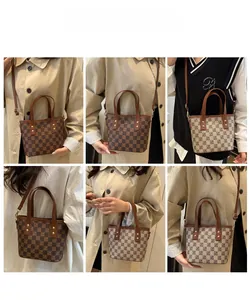Detail view of mini tote bags with checkerboard patterns and brown leather straps