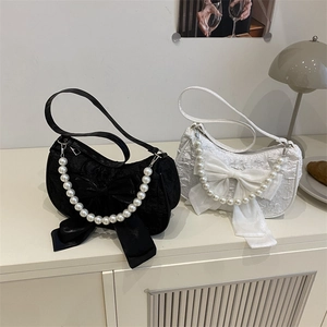 Elegant bow handbags with pearl straps in black and white minimalist croissant style