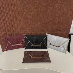 Sparkly snakeskin envelope bags with gold V-metal trim in burgundy, black, silver, and brown