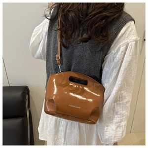 Brown glossy handbag showing the strap and fashion bags text in a styled lifestyle shot