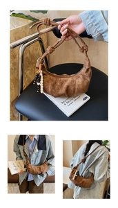 Detail of brown suede hobo bag with unique knotted strap and colorful wooden beads