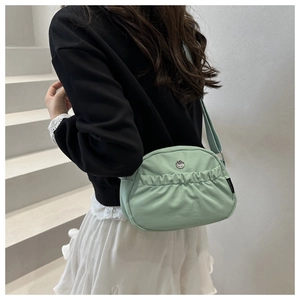 Detail of light green crescent nylon bag with pleats and silver metal buckle