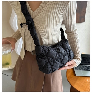 Détail du sac nuage noir matelassé avec bandoulière froncée et texture en nylon