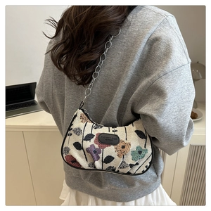 Detail showing vintage floral jacquard fabric underarm bag with silver chain strap