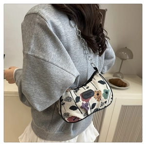 Detail of floral nylon shoulder bag with silver chain strap and leather logo patch