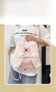 Detail of pink striped backpack with long bunny ear straps and plush star decorations