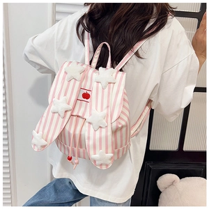 Detail view of cute pink and white striped backpack with rabbit ears and star patches
