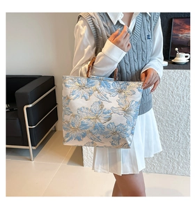 Detail of floral jacquard tote bag with vintage bamboo handles and textured fabric