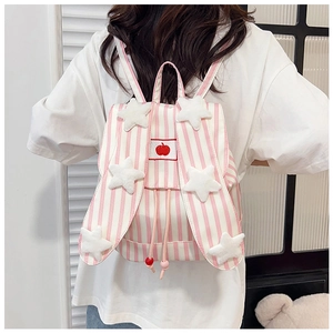 Detail of pink striped backpack with plush stars and apple embroidery on model