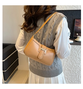 Chic light brown leather underarm bag styled with a modern casual outfit for women
