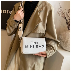 Minimalist white leather crossbody bag with The Mini Bag print and wide textile strap
