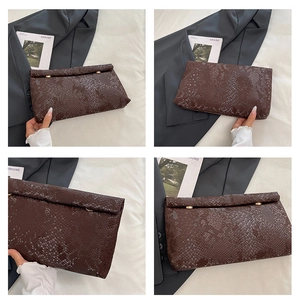 Detail shots of brown snakeskin envelope clutch with gold metal cylinder buckles