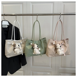 Detailed woven texture and cute dog charms on beige, green and pink tote bags