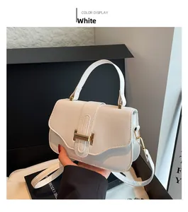 Detail of white lychee textured PU leather handbag with a gold H-shaped buckle closure
