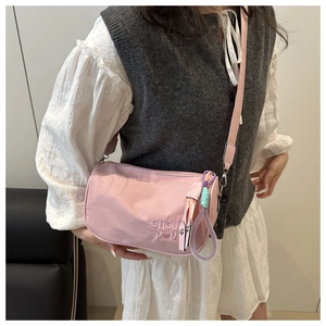 Pink bucket bag with CHOU DON embroidery and colorful braided pendant detail