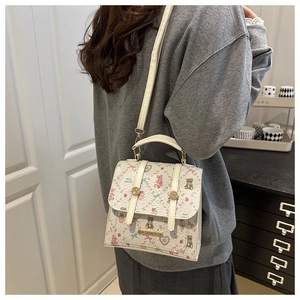 Cream floral crossbody bag featuring cute rabbit and bear prints with gold buckle detail