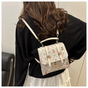Close-up of sweet cartoon printed backpack with heart and strawberry patterns