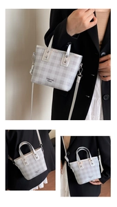 Detail of silver checkered mini bucket bag with metallic finish and detachable strap