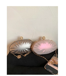 Detail of elegant pleated shell evening bags in silver and pink with pearl clasp and chain