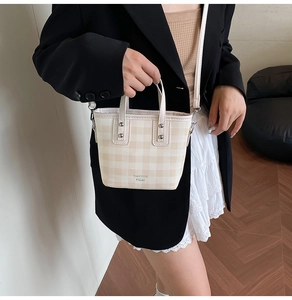 Detail of checkered bucket bag with dual handles and Tianyun Yicai brand logo