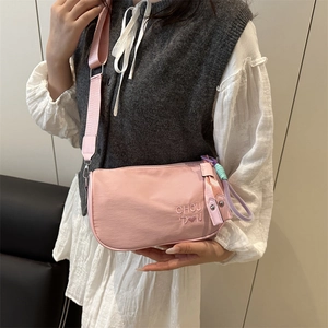 Pink nylon crossbody pillow bag with wide strap and heart embroidery for women