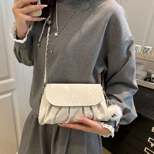 Beige ruched cloud crossbody bag with fashion chain strap and plush monster charm