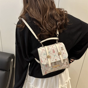 White mini backpack for women featuring cute bear floral print and golden buckle
