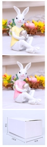 Detailed view of resin Easter bunny figurines holding silver eggs with size dimensions