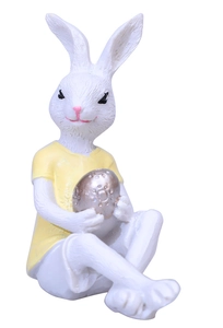 Detail of Easter bunny resin figurine holding an embossed silver egg with yellow shirt