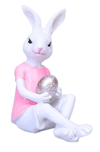 Detail of resin Easter bunny ornament wearing a pink shirt holding a silver relief egg