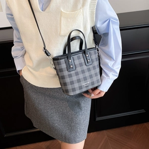 Chic grey checkered bucket bag with black handles and silver studs for women