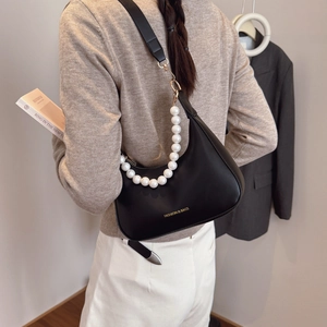 Elegant black crescent shoulder bag with pearl chain strap and polished leather finish