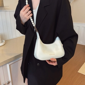 White crescent underarm bag with faux pearl strap and Fashion & Bags text on matte leather