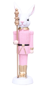 Detailed view of resin rabbit nutcracker soldier with pink uniform and golden scepter