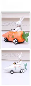 Detailed resin figurines of Easter bunnies driving carrot-shaped cars in various colors
