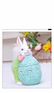 Detail of Easter resin bunny with green bag leaning on a lace-textured decorative egg