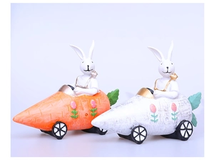 Detail of Easter resin bunny figurines driving carrot cars with floral painting