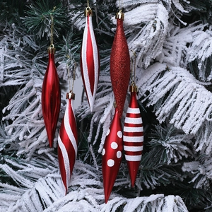 6-piece red and white spindle Christmas tree ornaments on snow-covered pine branches