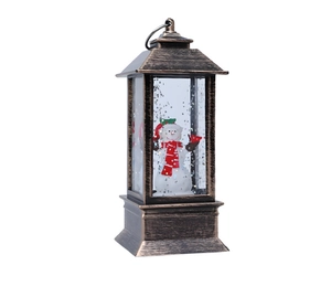Dettaglio di una lanterna di Natale in bronzo vintage con pupazzo di neve e globo di neve