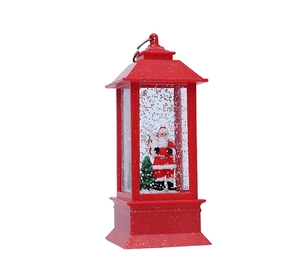 Dettaglio della lanterna natalizia rossa con Babbo Natale e glitter argentati galleggianti