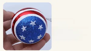 Detail of USA Independence Day hanging ball ornament with stars and red blue white glitter
