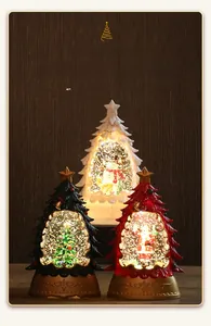 Close-up of lighted Christmas tree water lantern with swirling glitter and warm LED glow