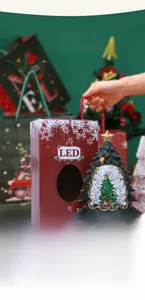 Close-up of LED Christmas tree snow globe with decorative box and miniature train