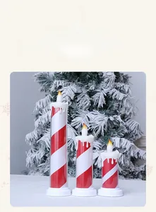 Close-up of red and white striped LED candles with dripping wax effect for Christmas