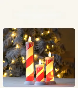 Detail of three LED flameless candles with red white spiral textures for Christmas decor