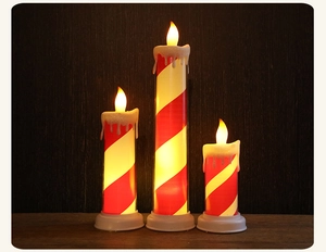 Three-piece set of red and white striped LED candles with melting wax effect and warm glow