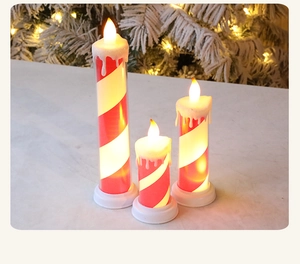Three sizes of LED flameless taper candles with red and white spiral festive candy stripes