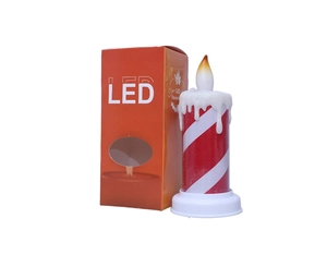 Close-up of red and white striped LED Christmas candle with its orange packaging box
